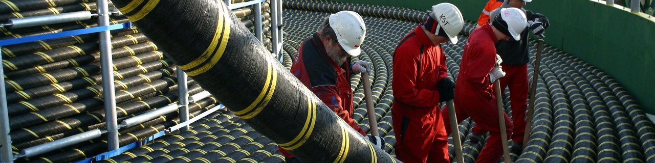 several men unroll huge power cable