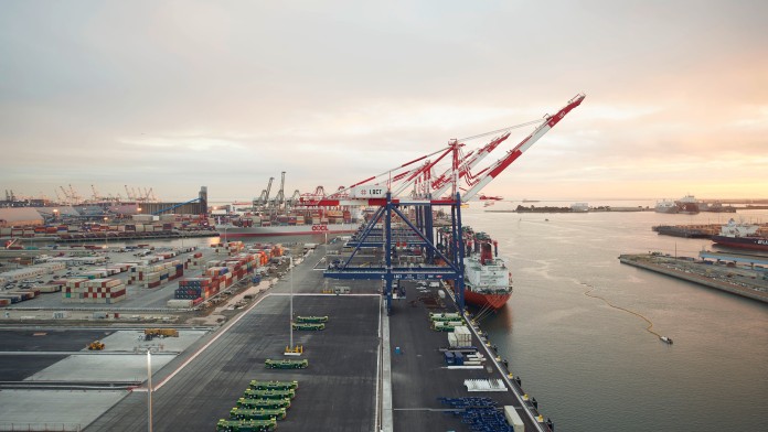 long green transport vehicle in container harbour