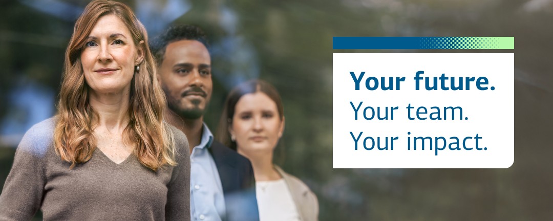 Woman in the foreground and a man and woman in the background looking at the camera