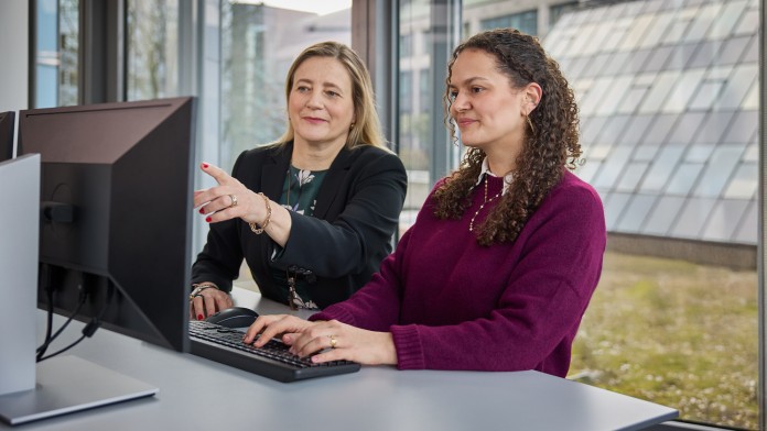 Erfahrene Kollegin und Praktikantin am Bildschirm