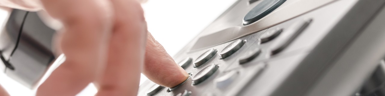 Hand operates a telephone keyboard