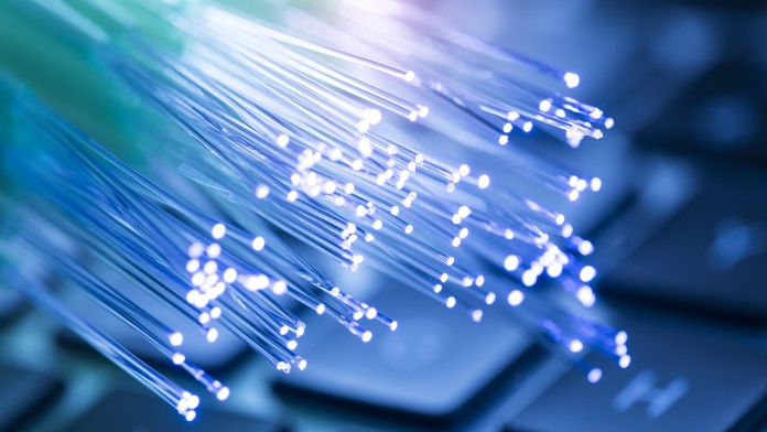 network cables and fiber optic closeup with keyboard background