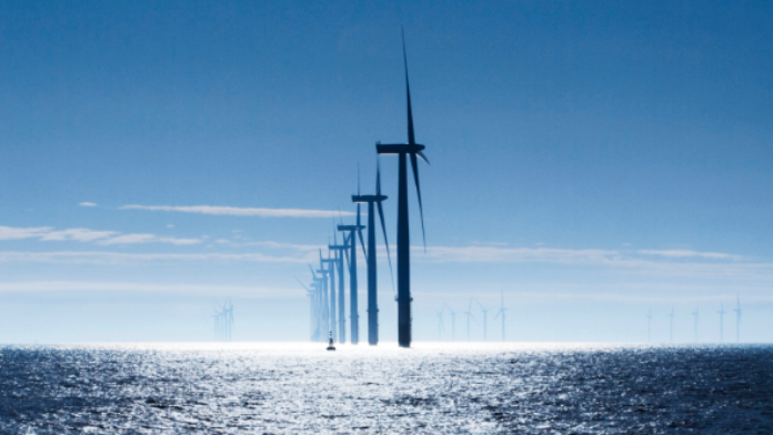 wind turbines in the sea against blue sky